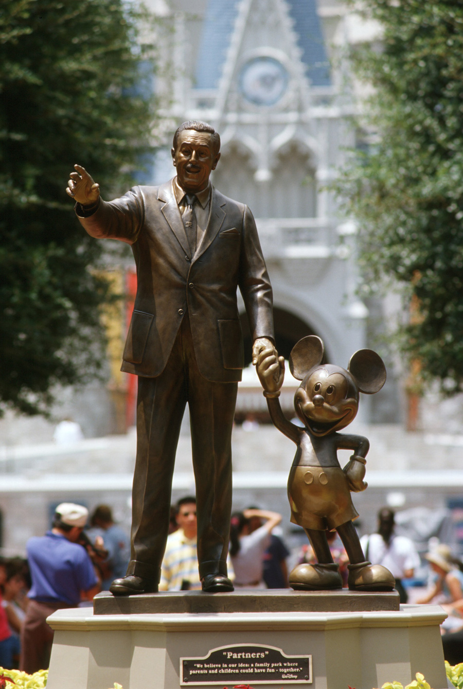 Walt Disney and Mickey Mouse statue in front of the Sleeping Beauty Castle.
