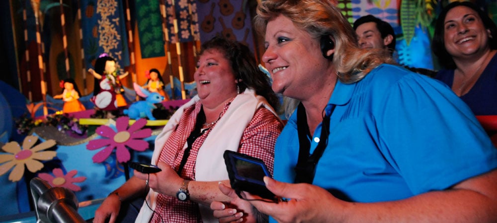 Guests with Disabilities: Disneyland guests smiling as they watch a show