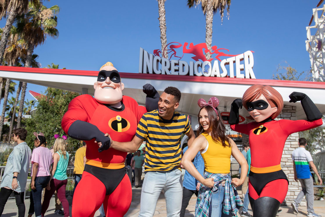 the Incrediables posing with couple on Pixar Pier