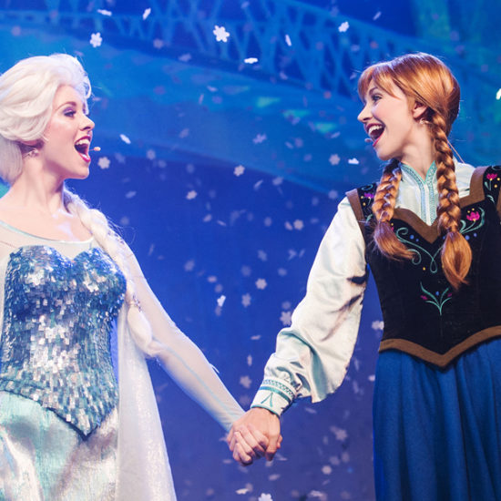 Anna and Elsa holds hang while singing