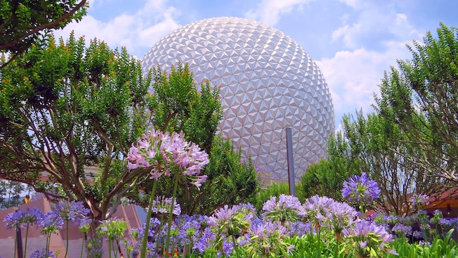 Epcot with flowers in front of it on a spring day