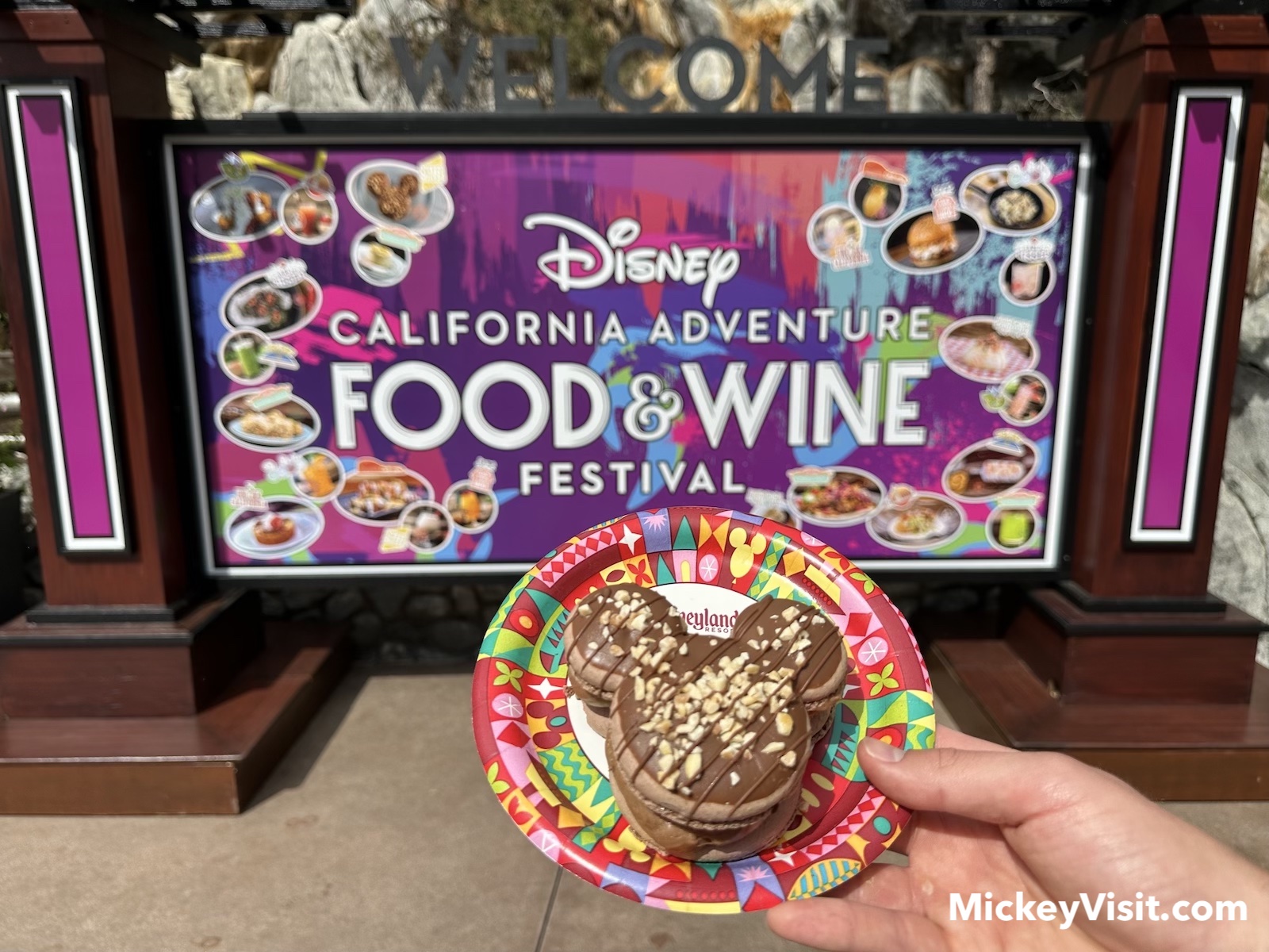 Mickey Mouse shaped treat in front of food and wine sign