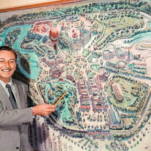 walt disney in front of a map at disneyland