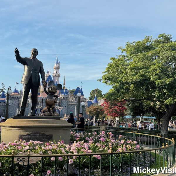 Disneyland castle and partners statue