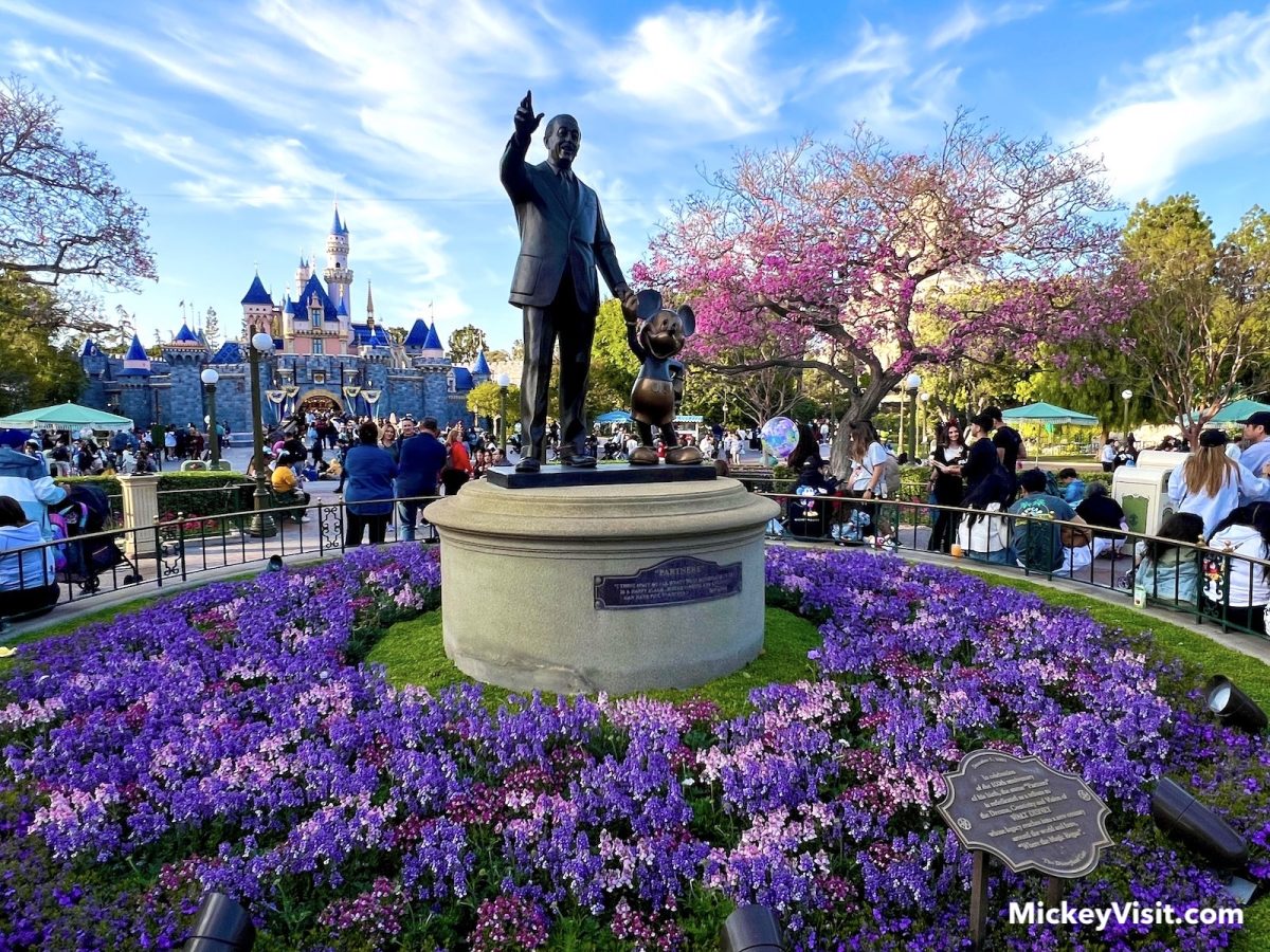 partners statue Disneyland purple flowers