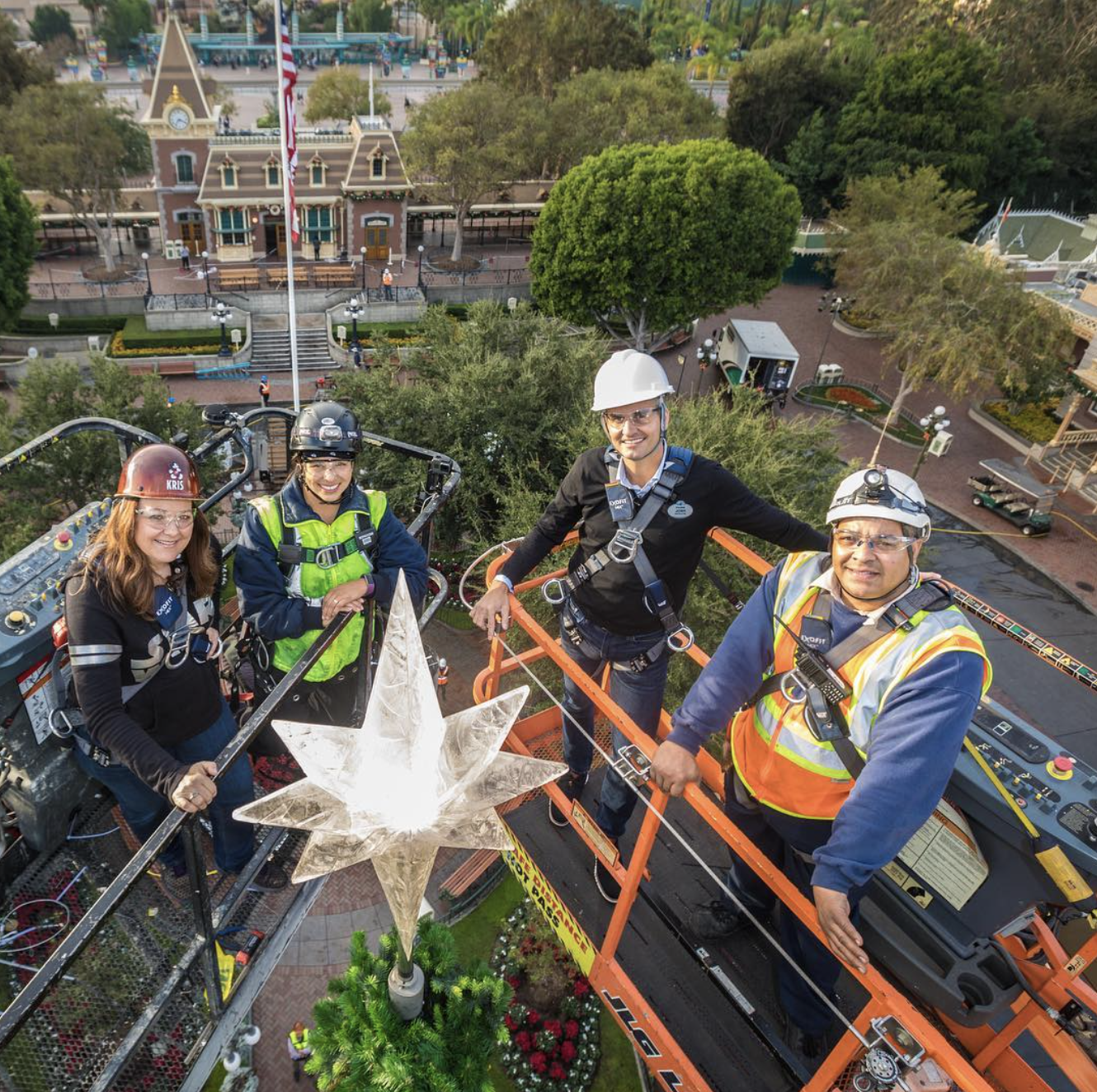 josh damaro in disneyland at top of the christmas tree