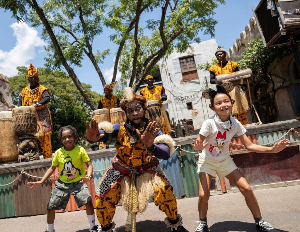Children dancing with a performer during live entertainment at Disney's Animal Kingdom
