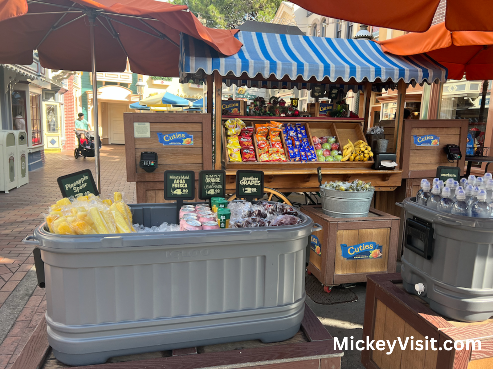A covered fruit stand and drink cooler at Disneyland