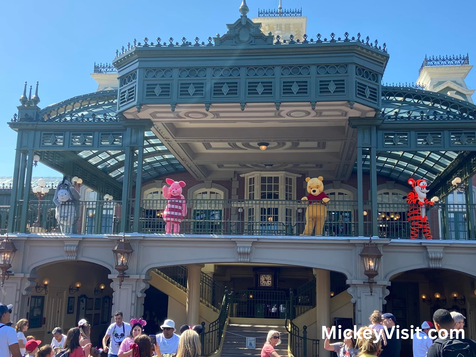 Pooh, Piglet, Tigger, and Eeyore waving at guests