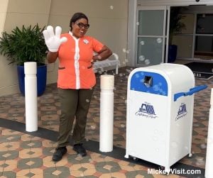 Disney World Cast Member waving with bubbles and Mickey glove