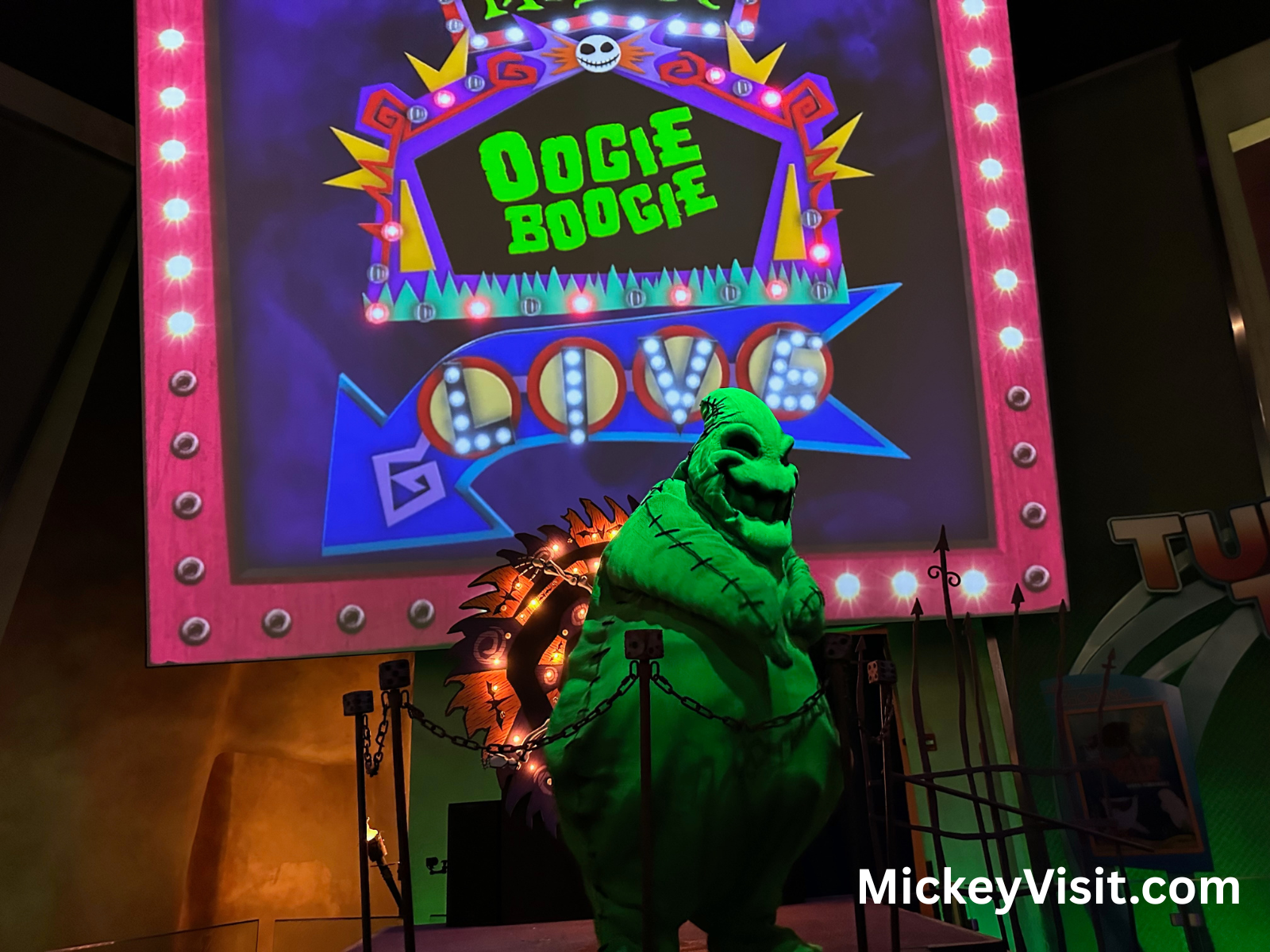 Oogie Boogie in front of Oogie Boogie Live sign
