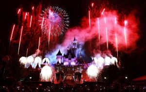 Red, white, and blue firework show in front of Disneyland castle