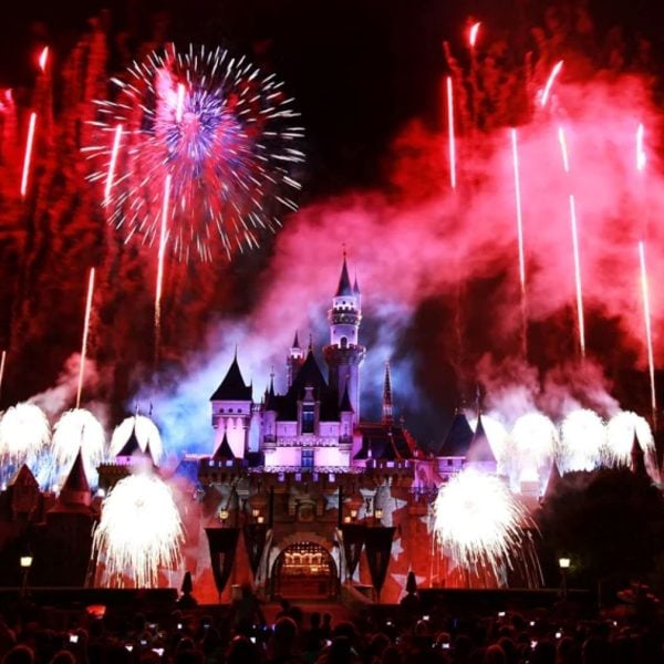 Red, white, and blue firework show in front of Disneyland castle