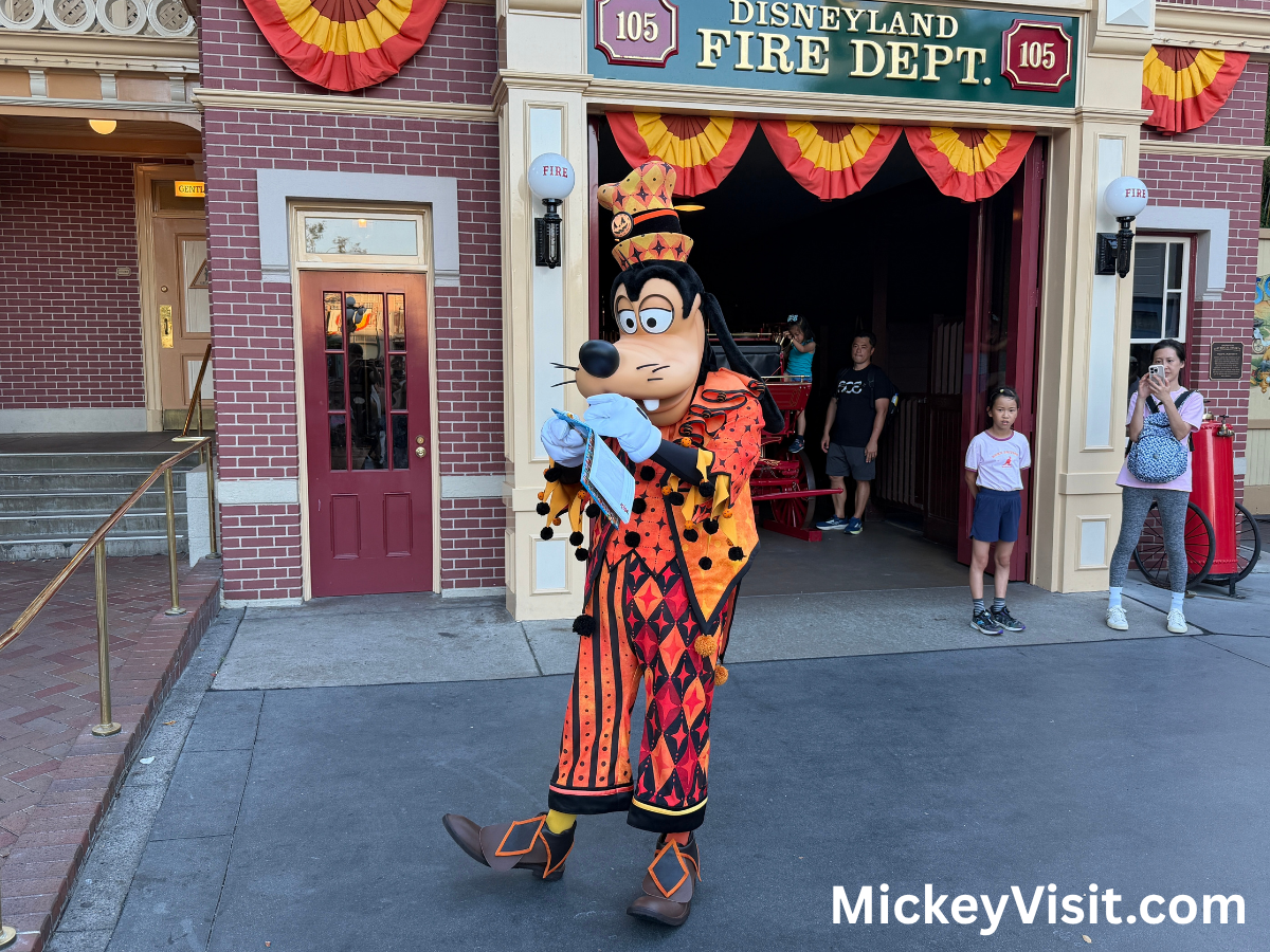 Goofy in Halloween orange outfit signing autograph