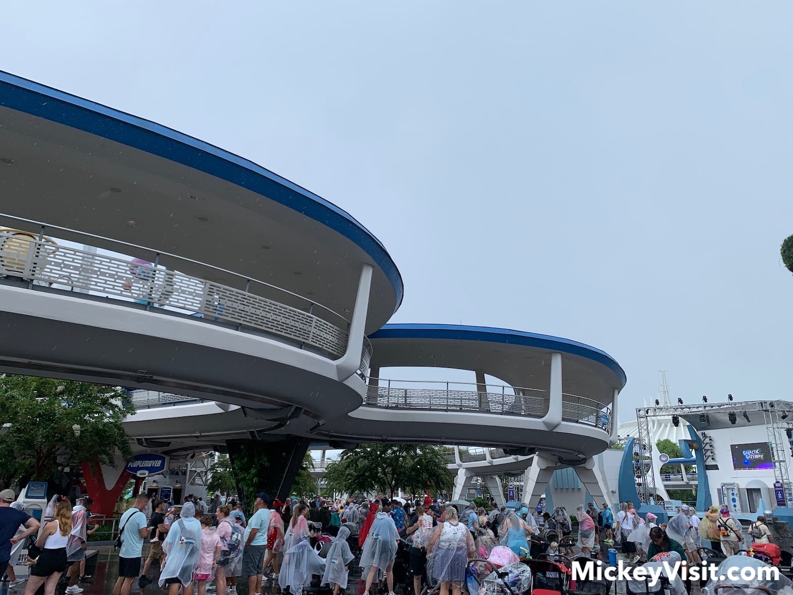 Magic Kingdom in rain with guests wearing ponchos