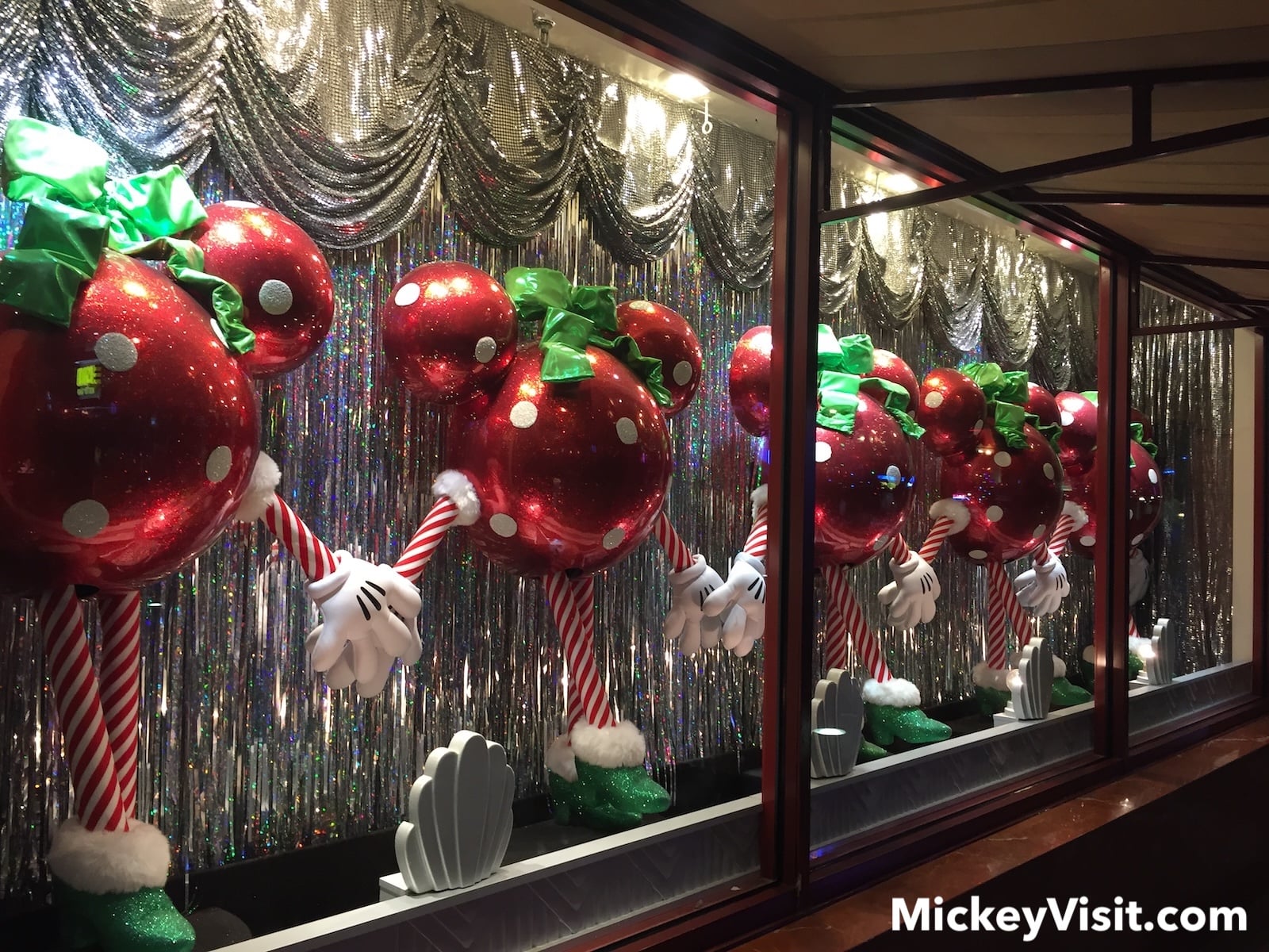 Giant ornaments dancing in a kick line in a store window