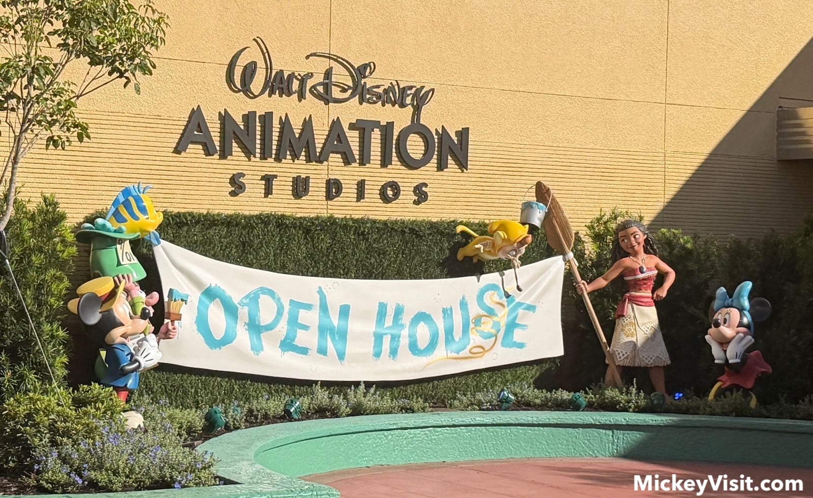 Statues of Disney characters with Open House sign