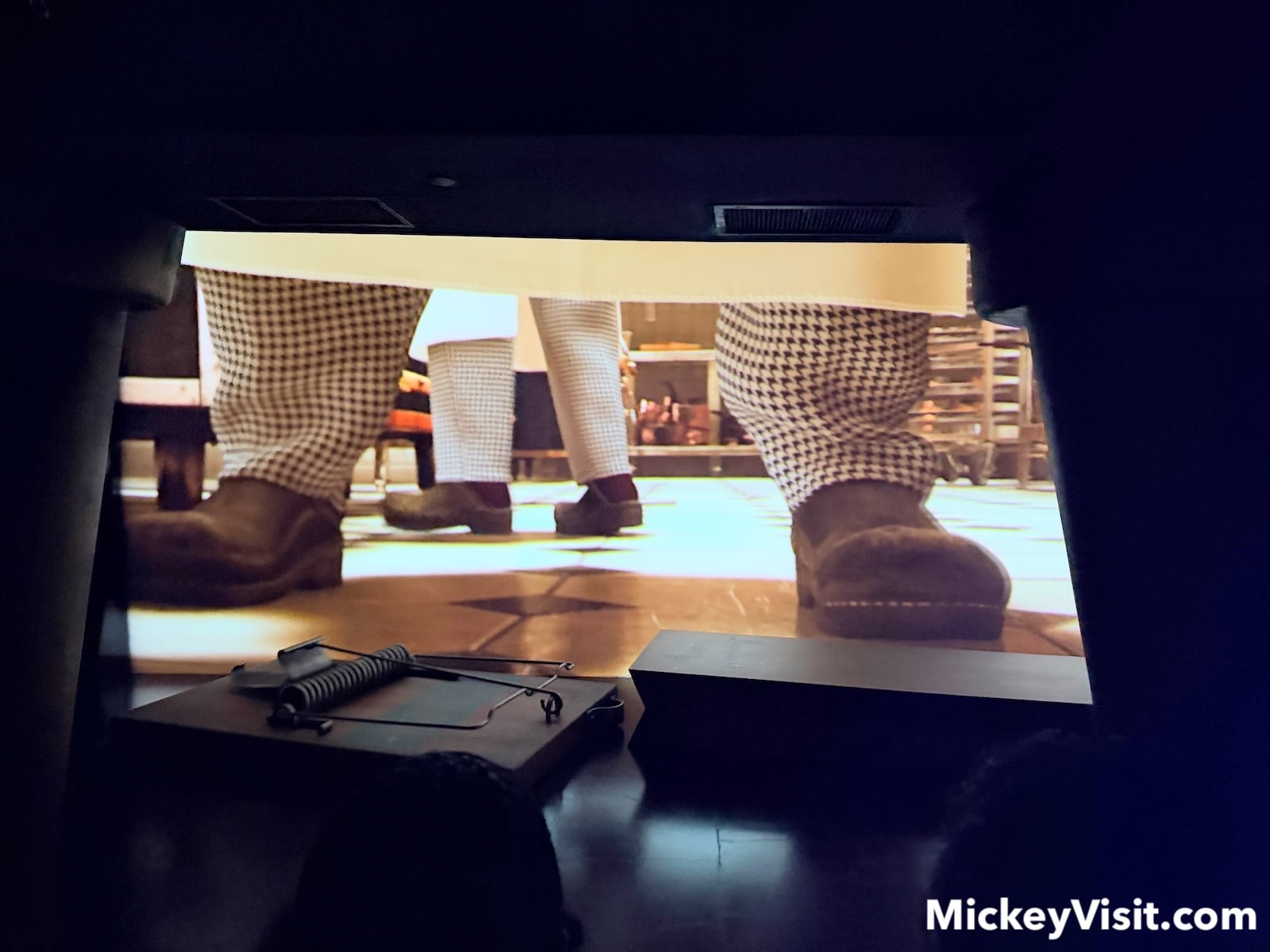 Large screen with and without huge mouse trap prop in front of it