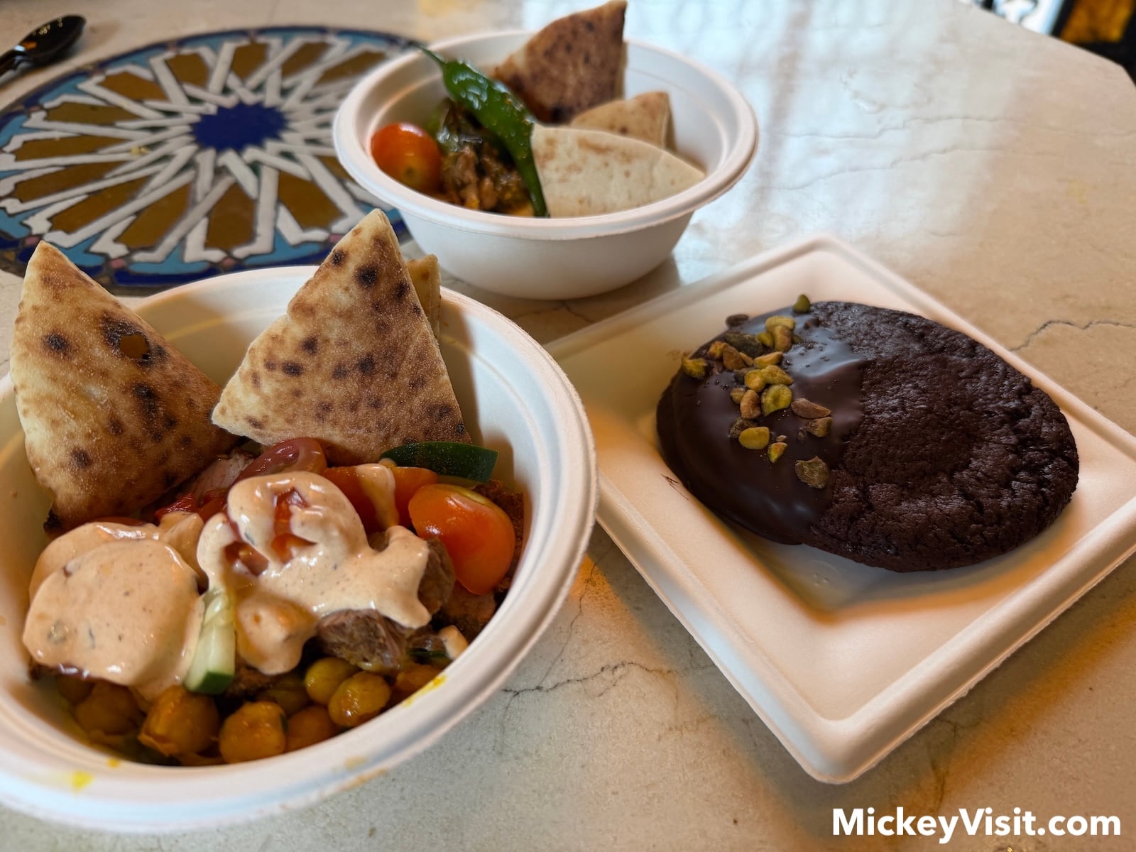 Food spread of chicken and steak bowls with chocolate cookie