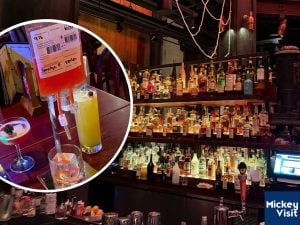 Drinks on table and alcohol on shelf
