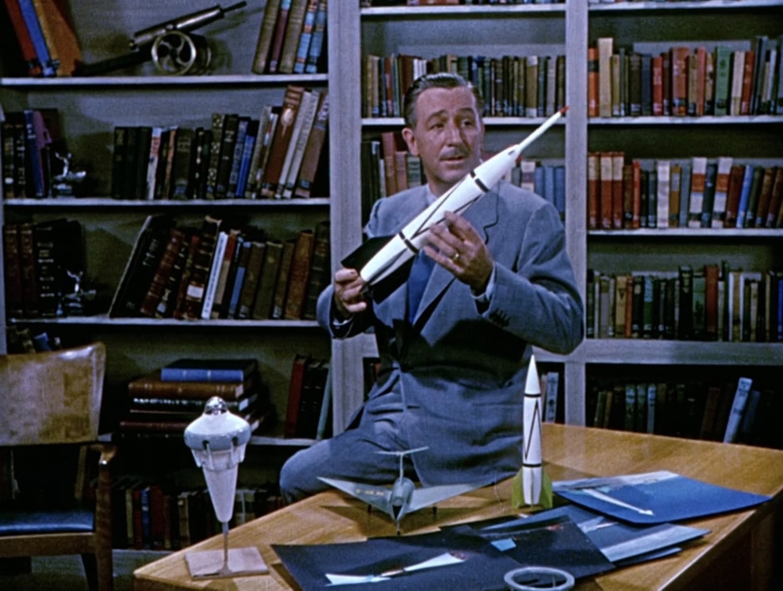 Walt Disney holding rocket model