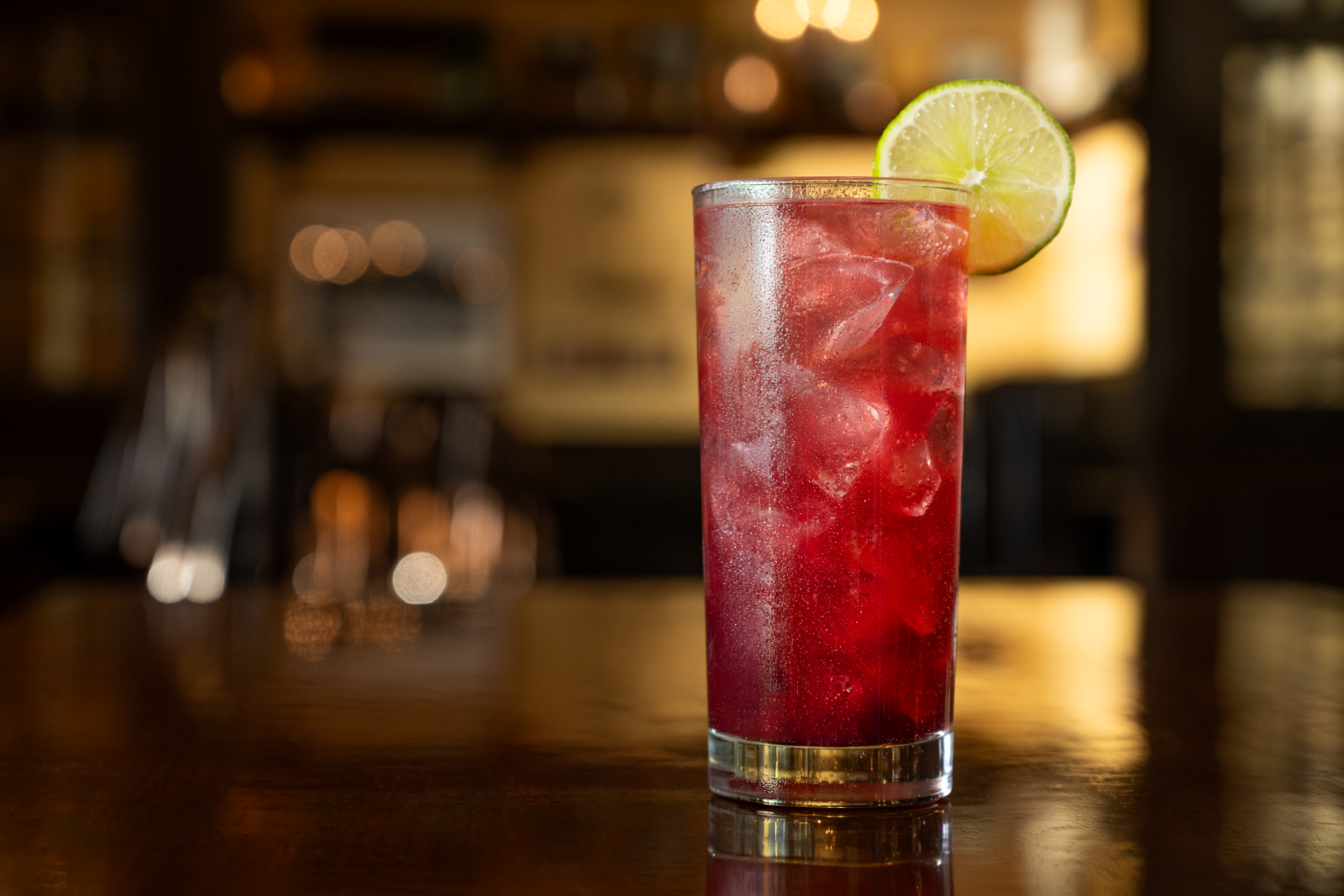 Pomegranate red Royal Berry Spritzer with lime garnish
