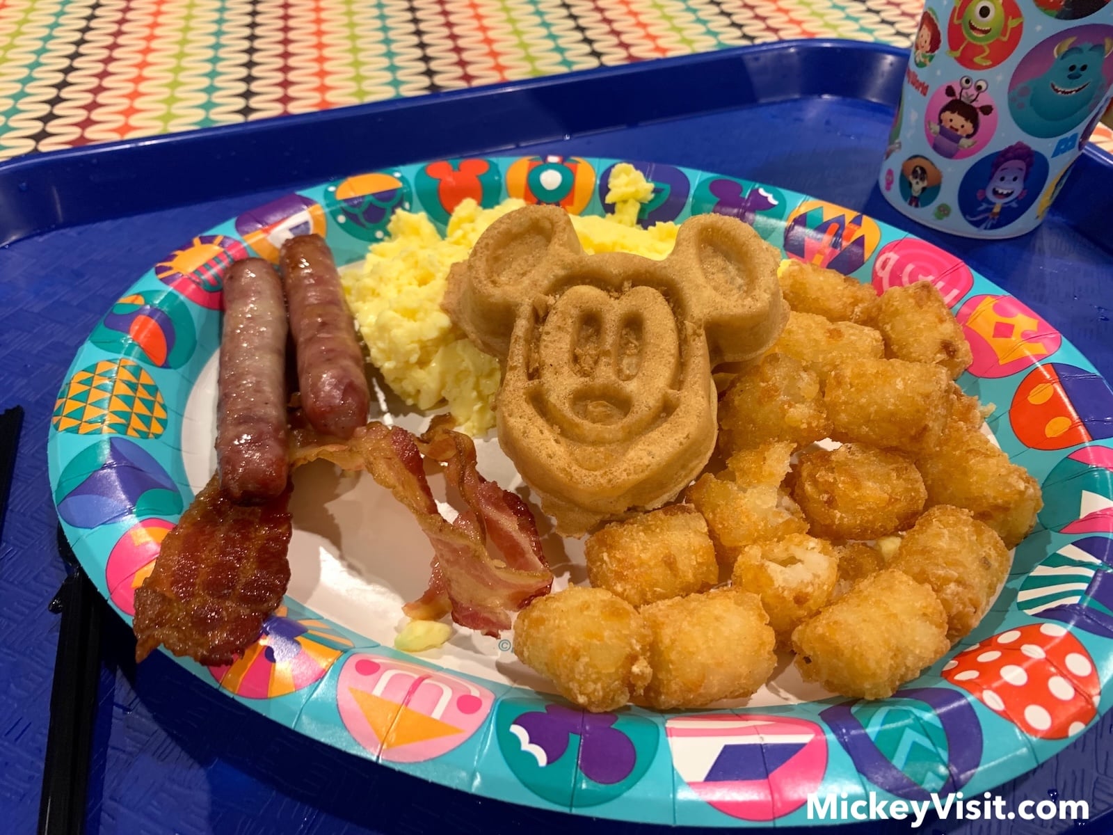Breakfast with bacon, sausage, eggs, and Mickey Mouse waffles