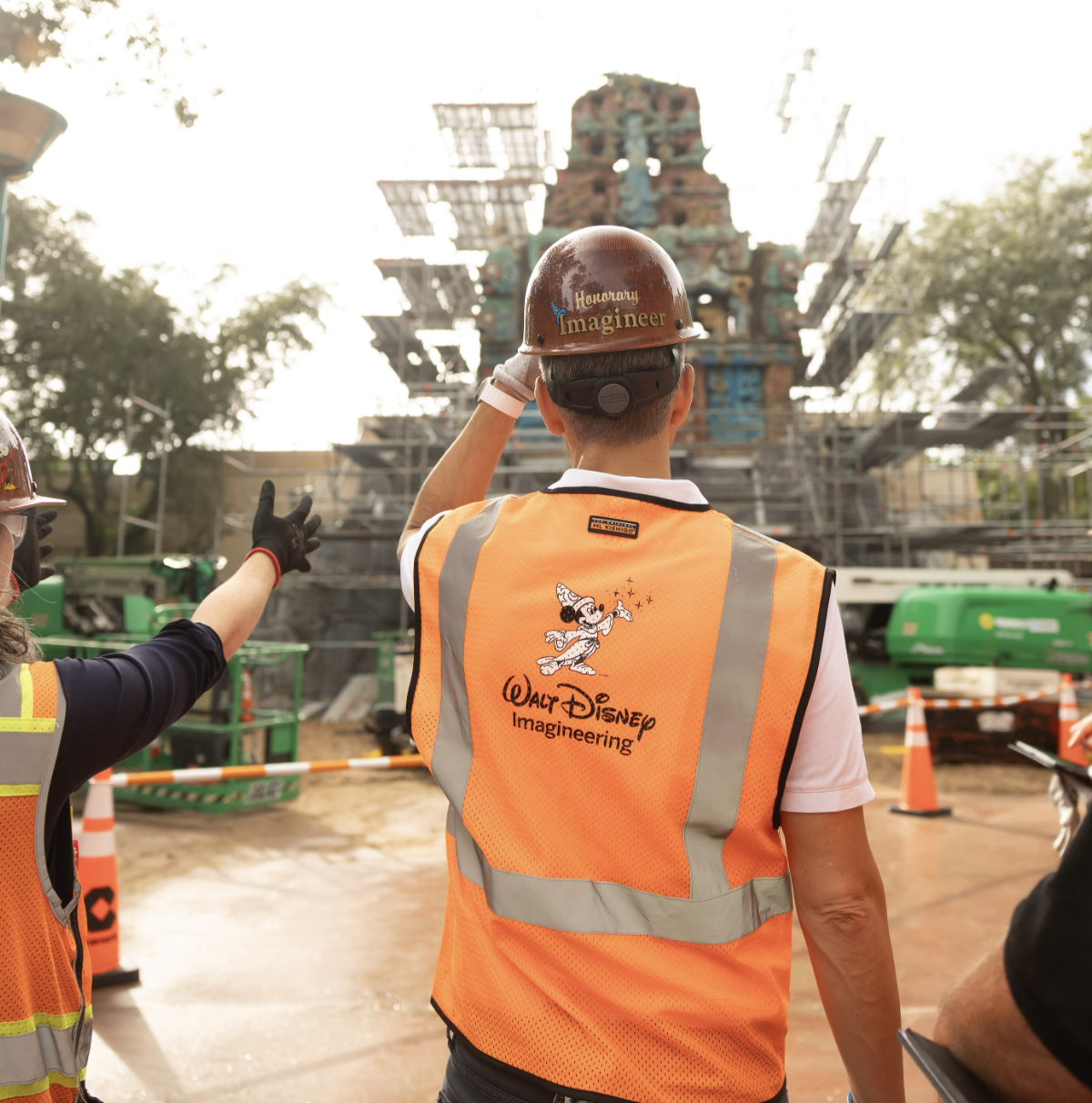 Man in hard hat in front of pyramid