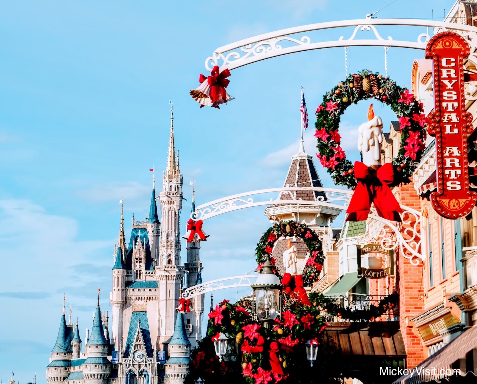 Holiday decorations on Main Street in Walt Disney World with Cinderella Castle in the background.