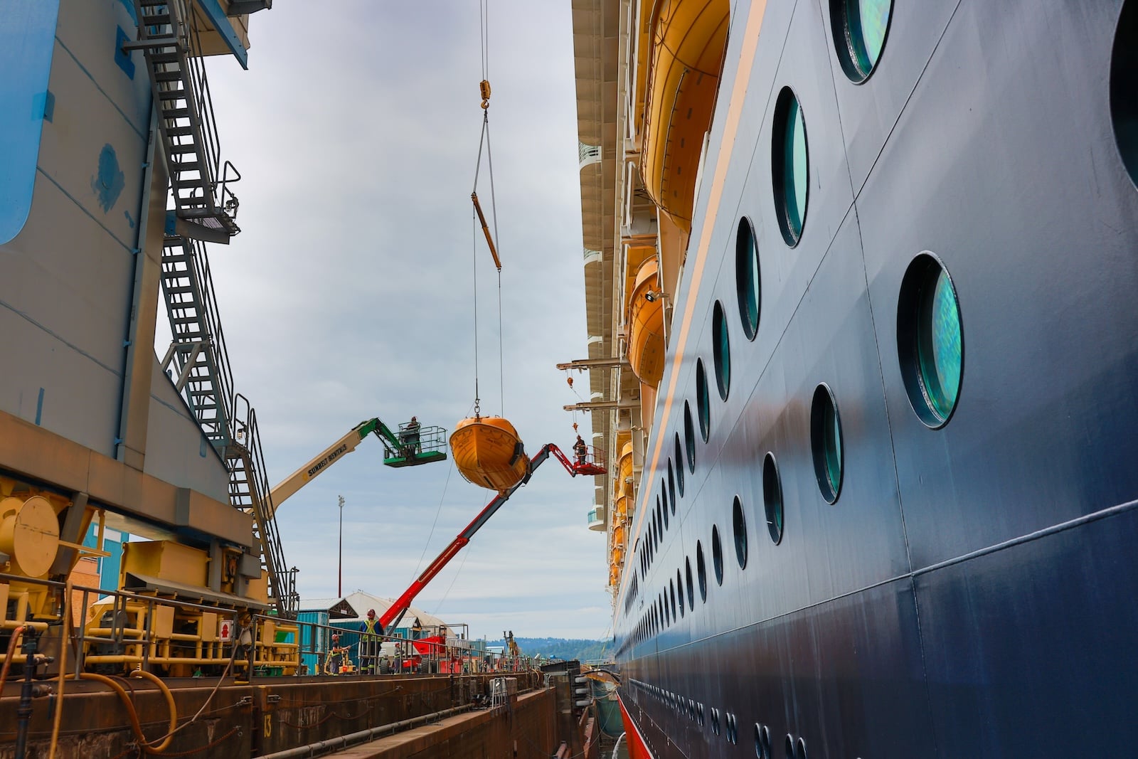 Workers performing maintenance on cruise ship
