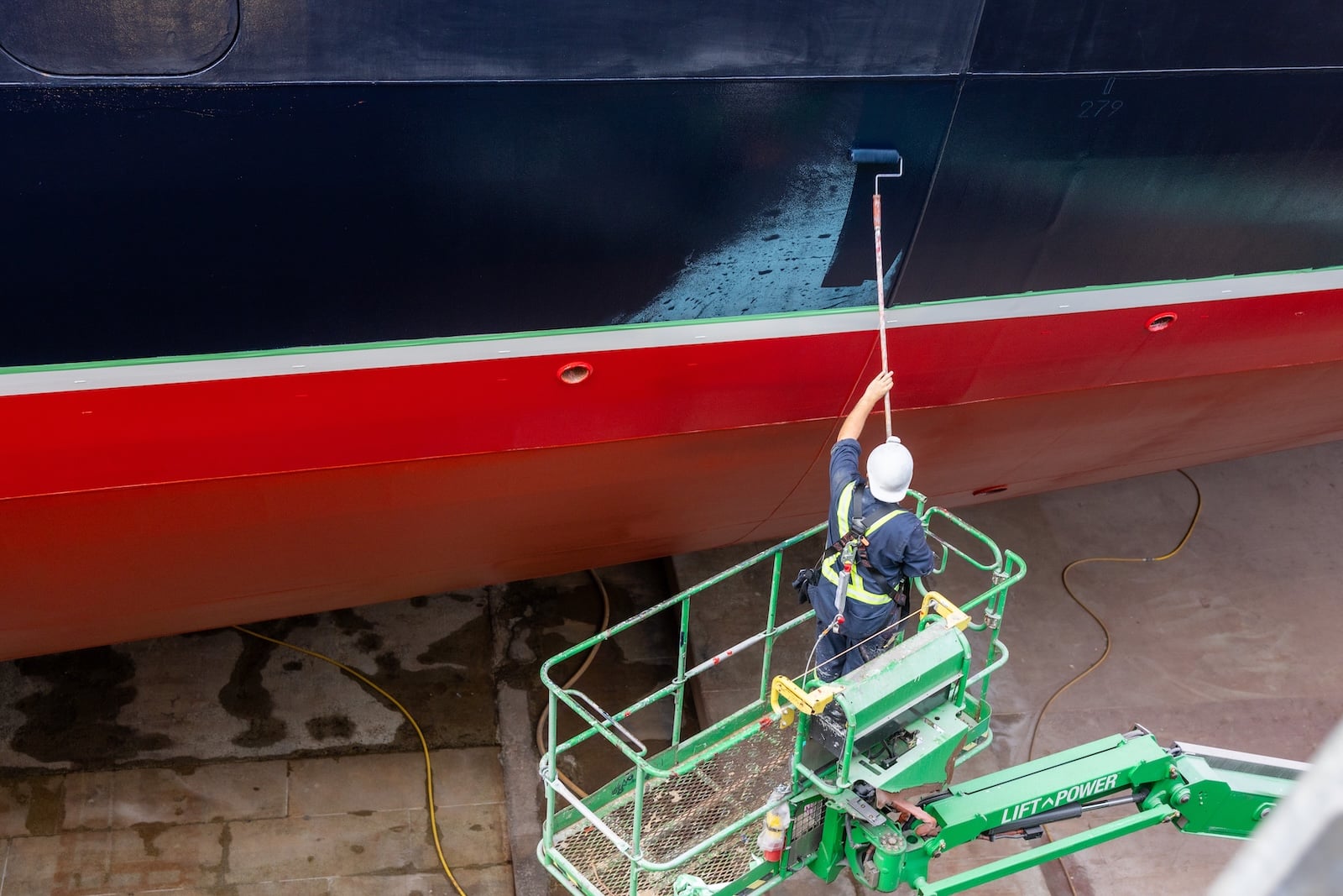Workers performing maintenance on cruise ship