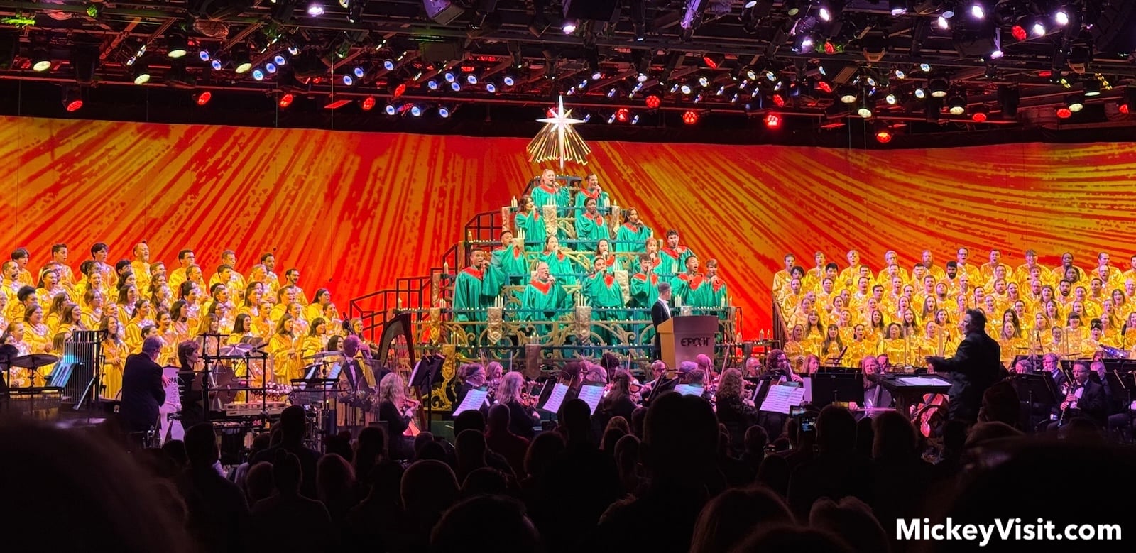 Choir on stage assembled in shape of Christmas tree