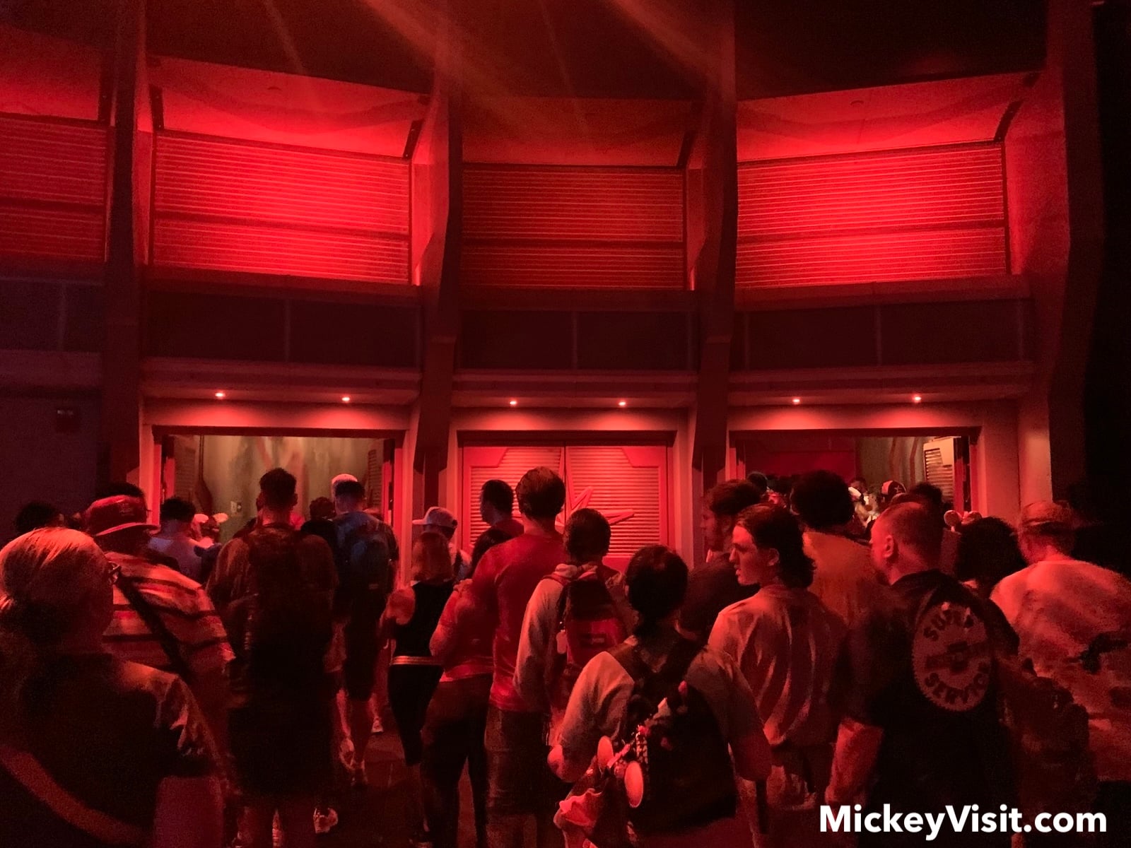 Crowd approaching Doors with red lights